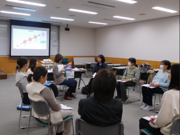 参加者がセミナー室で円になって講座を受講している様子