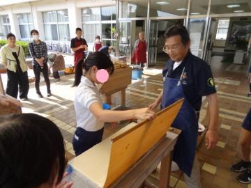 簾から和紙を外す6年生