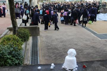 児童玄関前で見送る雪だるま