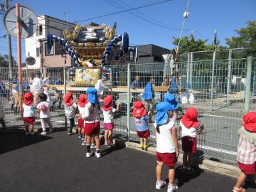 園内から屋台を見送る園児たちの様子