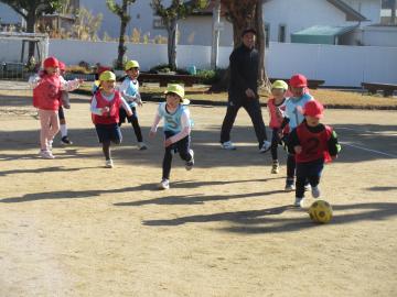 園庭でサッカーで遊んでいる園児たちの様子