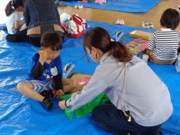 幼児と保護者がこいのぼりを作っているところ