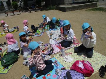 公園で弁当を食べる子供たち