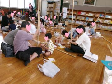 5歳児と保護者が竹馬をつくっているところ
