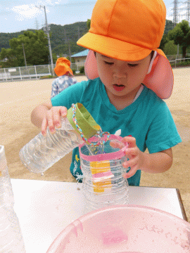 水移しをして遊ぶ幼児
