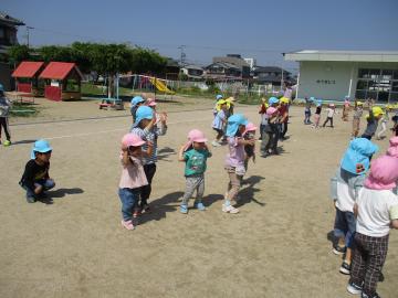 園庭で園児がどうぶつ体操をしている様子
