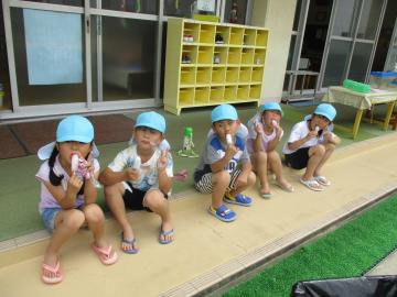テラスに座ってアイスを食べる子供(1)