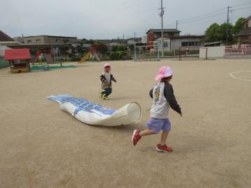 大きなこいのぼりと運動場を走る子ども1