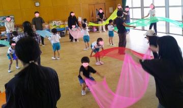 カラフルな布をもって遊んでいる写真