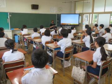 6年生が本の読み聞かせに聞き入るようす