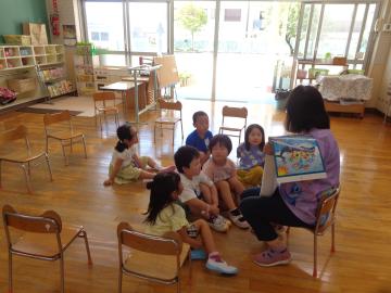 室内で幼児が2学期の予定を聞いている様子