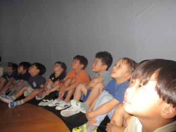 プラネタリウムを見る幼児