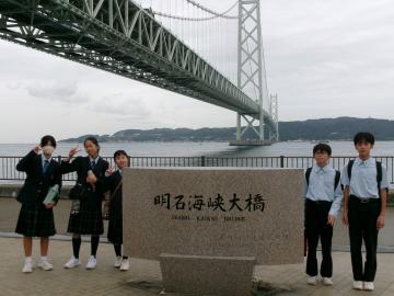 明石海峡大橋をバックに記念撮影の様子