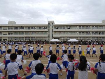 小学校の校庭で応援している児童たちの様子