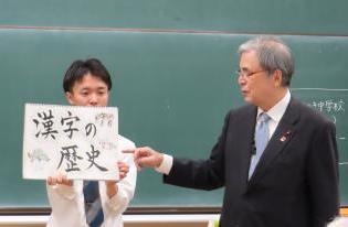 先生から文字の成り立ちのお話を聞く