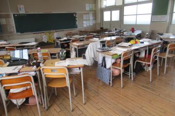 教室内で児童が机の下で身の安全を確保している様子
