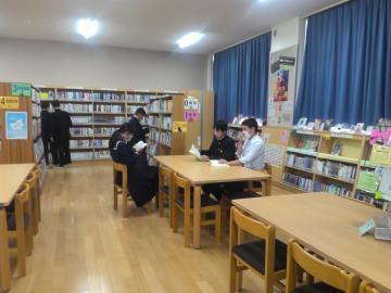 図書室の椅子に座って読書をする生徒たち