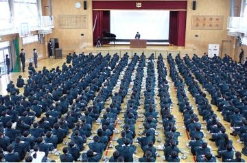 体育館で、終業式での校長先生のお話を聞いている生徒たちの様子