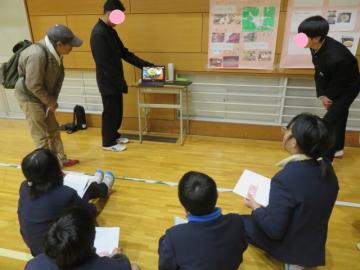 体育館内で夢王をつかったチャーハン紹介動画を視聴する参加者の様子