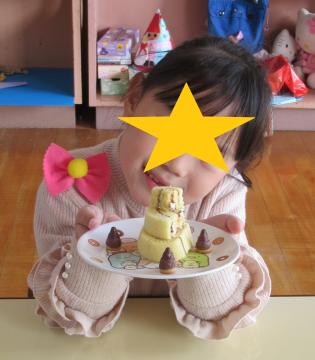 自分で飾り付けたケーキと一緒に記念撮影する子ども1