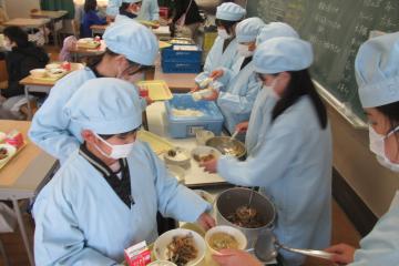 教室で5年生が給食を配膳している様子