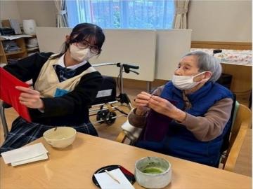 生徒がご老人に作法を教えている様子