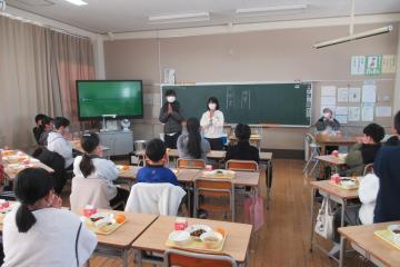 教室内で6年生が給食前のいただきますをしている様子