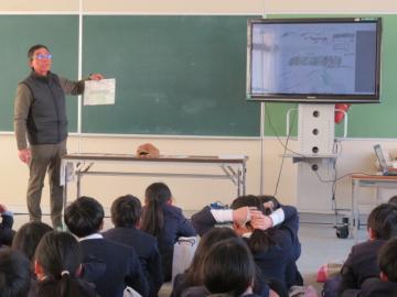 教室内で学校のようすを絵に描いて説明くださる長寿会会長の様子