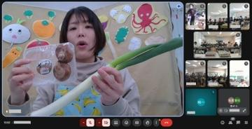 ネギなどを持ち、兵庫県産の野菜を紹介する栄養教諭の様子