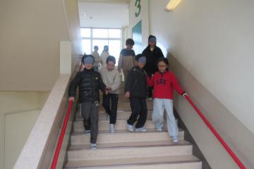 校舎内で3年生がアイマスクをして階段を降りている様子