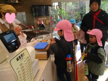 レジで自分の財布からお金を出して支払う子供