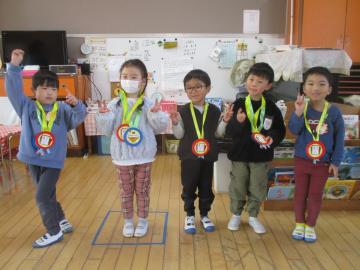 室内でメダルをもらって喜ぶ子供