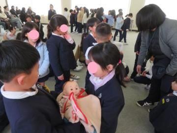 教室でいのちの授業で赤ちゃん人形をだっこする1年生の様子
