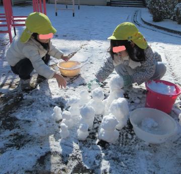 雪だるまをつくる子ども達