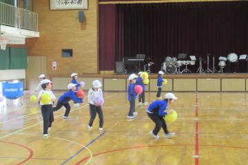 体育館で1年生がボール投げをしている様子