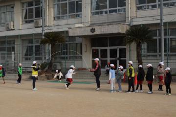 校庭で子どもたちが縄跳びをしている写真