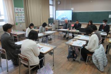 4校園の代表者が口の字形に着席し情報交換をしている様子