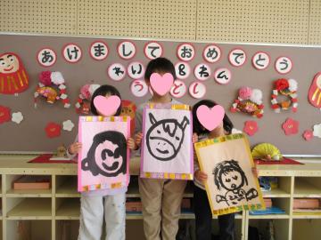 書初めをもって集合写真を撮る4歳児たちの様子