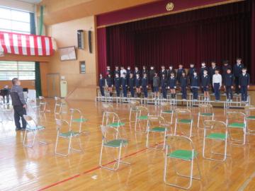 体育館のひな壇に並ぶ生徒たち