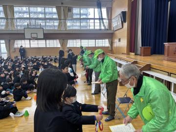 見守り隊のかたへ感謝状とメダルを渡しているところ