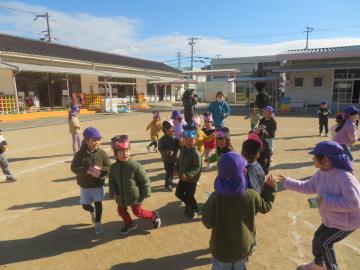 園庭で豆まきをしている園児たちの様子