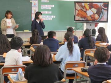 教室の前に立ってモニターを使いながら発表する生徒と、席に座って聞く生徒たち1