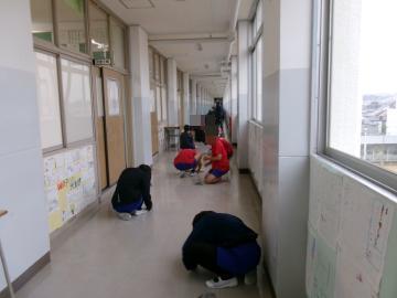 校舎内の廊下を掃除している生徒たちの様子