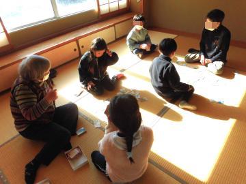 お年寄りとかるた遊びをしている様子