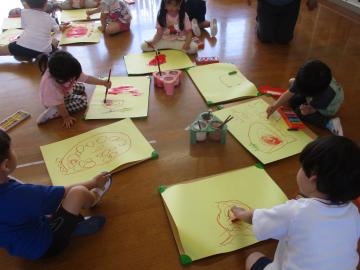 幼児がイチゴの絵をかいている