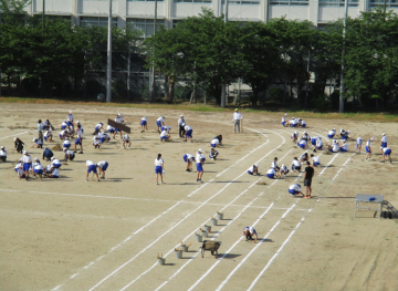 運動場に多くの生徒たちが集まって、環境整備を行っている様子