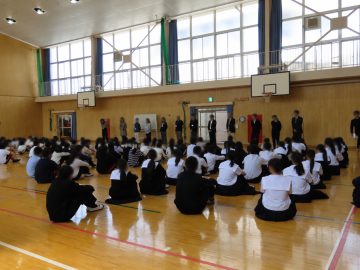 合同集会で、新着任の先生方が前に整列されている様子です