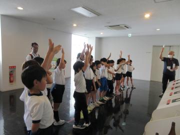 エコパークあぼしの館内で、施設の方の話を聞く児童たちの様子。講師の問いかけにみんなで挙手しています。
