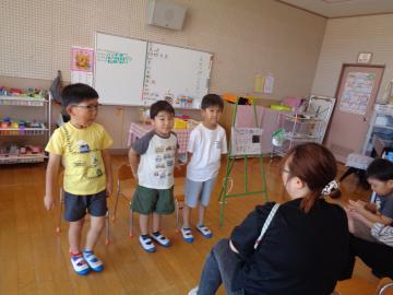 室内で家族に水族館の発表をする園児たちの様子