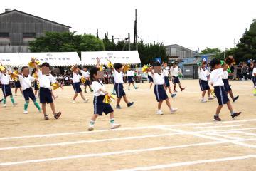 1年生と2年生の児童たちが校庭でダンスを踊っている様子